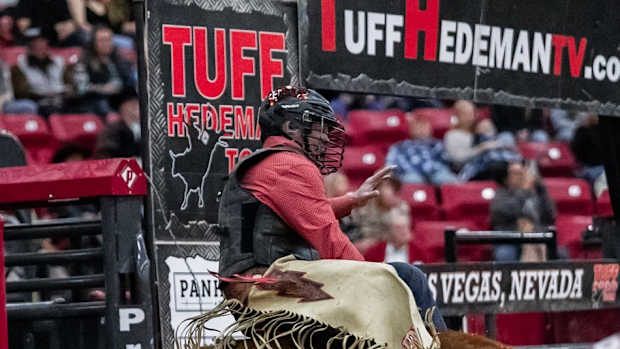 Barry Odom riding a bull